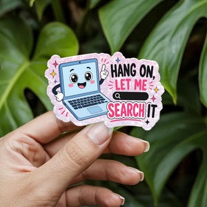 May include: A die-cut sticker with a glittery pink background featuring a cartoon laptop with a smiling face and arms. The text reads HANG ON, LET ME SEARCH IT, accompanied by a search bar icon and small colorful star accents surrounding the design.