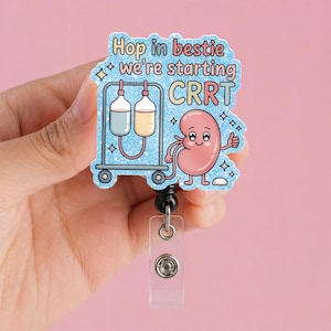 May include: A light blue badge reel with the text "Hop in bestie we're starting CRRT". The badge features a cartoon kidney giving a thumbs up and a medical IV drip. The reel has a clear plastic strap and a black retractable cord.
