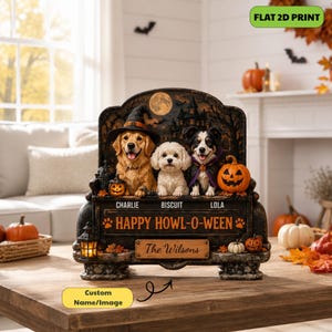 May include: A decorative Halloween-themed tabletop display featuring three dogs sitting on a bench. The dogs are named Charlie, Biscuit, and Lola. The text reads "HAPPY HOWL-O-WEEN" and "The Wilsons". The scene includes a haunted house, a full moon, pumpkins, and a lantern.