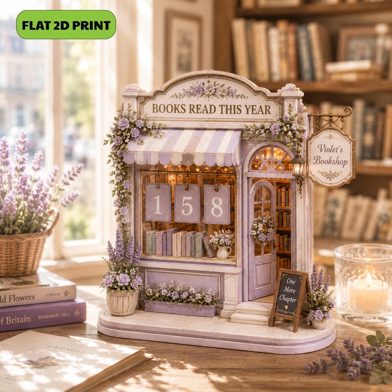 May include: A miniature bookshop model in shades of lavender and white, featuring a striped awning, a hanging sign reading Violet's Bookshop, and a front display with the numbers 158. The structure includes floral accents, interior lighting, and a small sidewalk sign that reads One More Chapter.