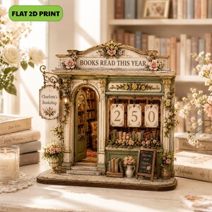 May include: A miniature bookshop display titled 'BOOKS READ THIS YEAR' with a hanging sign reading 'Charlotte's Bookshop'. The structure features a green facade, floral accents, and a front window displaying the number '250' with a small chalkboard sign that reads 'Just one more chapter'.
