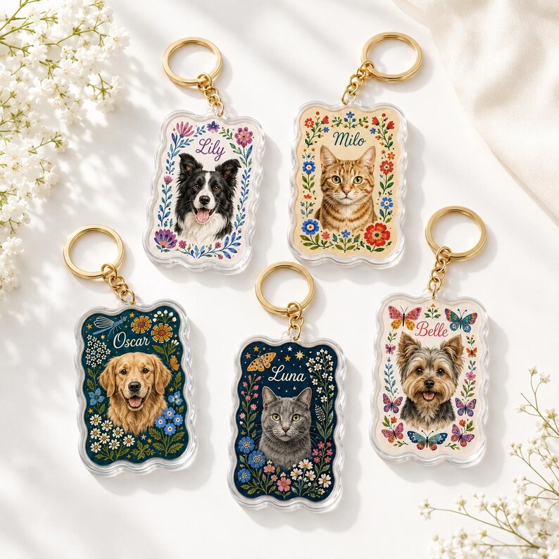 May include: Five rectangular acrylic keychains with scalloped edges, each featuring a portrait of a pet&mdash;a border collie, tabby cat, golden retriever, gray cat, and yorkshire terrier&mdash;surrounded by floral illustrations and names Lily, Milo, Oscar, Luna, and Belle.