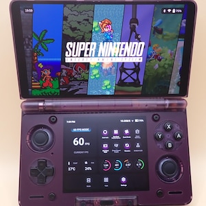 May include: A purple handheld gaming console with a screen displaying a Super Nintendo game. The console has a second screen below with performance metrics. The date 2026/01/12 is visible on the right side.