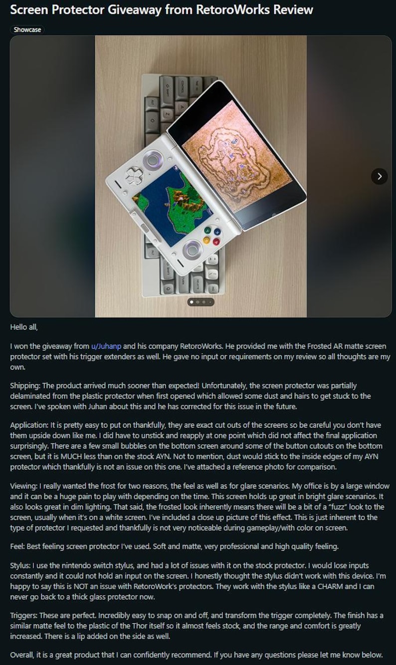 May include: A white and silver handheld gaming device with a screen displaying a colorful game, resting on a keyboard. The device is open, showcasing the screen protector. The image is a review of a screen protector.