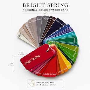 May include: A Bright Spring personal colour swatch card fan featuring a spectrum of colours including neutrals, blues, greens, yellows, and reds. Each individual card measures 3 cm by 7 cm, with the text Bright Spring printed on the cards.