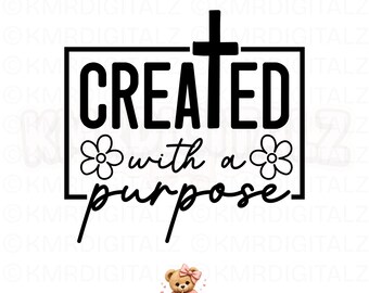 May include: A black graphic design featuring the text CREATED with a purpose in a mix of block and script fonts. A cross extends from the top of the frame, and two simple five-petaled flowers are positioned on the left and right sides.