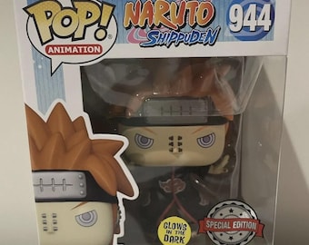 May include: A Funko Pop! vinyl figure of Pain (Almighty Push) from Naruto Shippuden. The figure is in a box with the text "POP! Animation" and "Naruto Shippuden 944." The box also has a "Special Edition" sticker and a "Glows in the Dark" sticker.