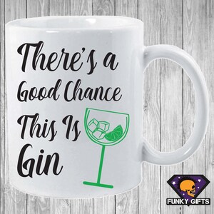May include: White ceramic mug with a black and green design. The mug has black text that reads "There's a good chance this is gin" and a green illustration of a gin glass with ice cubes and a lime wedge.