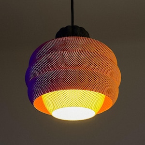 May include: A modern pendant light fixture with a textured, orange-red shade. The shade has a spherical shape with a patterned surface and a contrasting yellow-orange interior. The light hangs from a black cord.