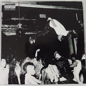 May include: A CD case featuring the album cover for "Die Lit" by Playboi Carti. The black and white image shows a crowd of people and a person upside down. The case has a parental advisory warning.