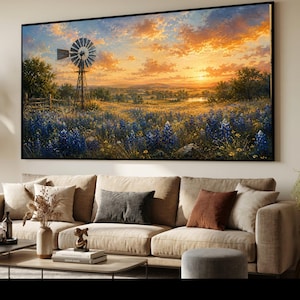 May include: A rectangular wall art print featuring a landscape painting of a field of bluebonnets under a vibrant orange and yellow sunset sky. A metal windmill stands on the left side of the field, with trees and a distant pond visible.