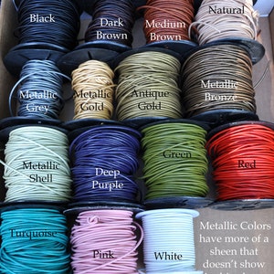 May include: A variety of leather cord colors, including black, brown, gold, grey, green, red, purple, turquoise, pink, and white. The cord is wound around spools. The text "Metallic Colors have more of a sheen that doesn't show in this photo." is written below the spools.