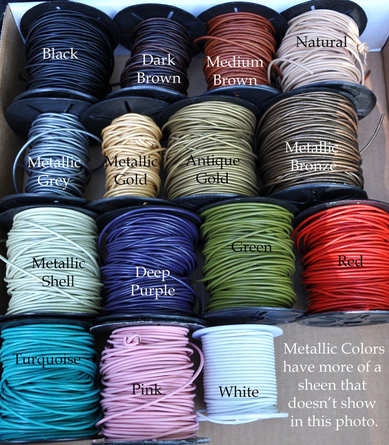 May include: A variety of leather cord colors, including black, brown, gold, grey, green, red, purple, turquoise, pink, and white. The cord is wound around spools. The text "Metallic Colors have more of a sheen that doesn't show in this photo." is written below the spools.
