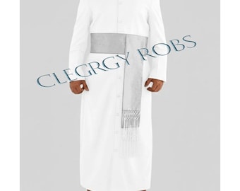 May include: A white clergy robe with long sleeves and a button-down front. A silver sash is worn around the waist, and the text "CLERGY ROBS" is printed on the image. The robe is a formal garment.