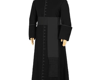 May include: A black clerical cassock with a mandarin collar, long sleeves, and a button-down front. A black sash is worn around the waist, and a black stole with fringe hangs down the front. The garment is designed for religious use.