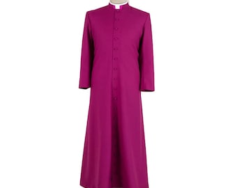 May include: A long, magenta-colored clerical robe with a mandarin collar and a row of buttons down the front. The robe has long sleeves and a white collar. The garment is displayed on a mannequin.