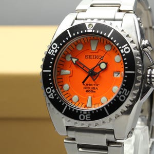 May include: A set of three ceramic mugs with a speckled, matte finish. The mugs are in shades of cream, light gray, and dark gray. Each mug has a simple, minimalist design, perfect for coffee or tea.