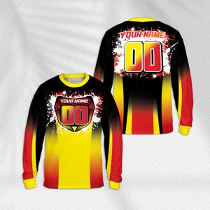 May include: A long-sleeved jersey featuring a black, yellow and red gradient design with white paint splatter accents. The front displays a shield graphic with the text YOUR NAME and 00, while the back shows the text YOUR NAME and 00.