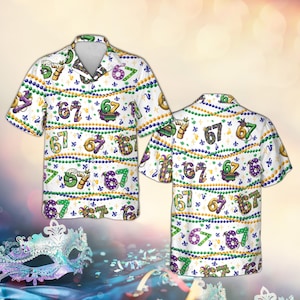May include: White button-down shirt with a Mardi Gras theme. The shirt features a repeating pattern of the number "67" in various colors, along with fleur-de-lis and bead designs. The shirt has short sleeves and a collared neckline.