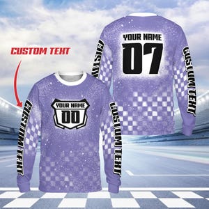 May include: A long-sleeved, lavender shirt with a white collar and cuffs. The shirt features a checkered pattern and the text "CUSTOM TEXT" on the sleeves. The front displays a shield with the text "YOUR NAME" and the number "00". The back has "YOUR NAME" and the number "07".