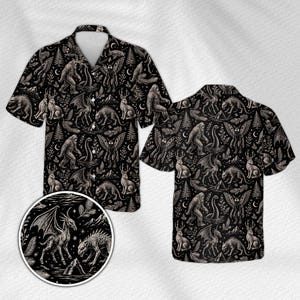 May include: A short-sleeved button-down shirt in black featuring an all-over print of mythical creatures including Bigfoot, the Loch Ness Monster, Mothman, and jackalopes, interspersed with pine trees, mountains, and crescent moons.
