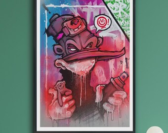 May include: A framed wall art print featuring a graffiti-style illustration of a character wearing a cap with a small smiling face icon, holding a spray paint can and a small toy figure, set against a vibrant background of blue, pink, and red.