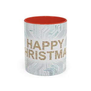 May include: White ceramic mug with a red interior and the words "HAPPY CHRISTMAS" in a binary code font. The mug features a circuit board design on the exterior.