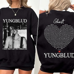 May include: Black sweatshirt featuring a black and white image of a singer with the text "YUNGBLUD" above the image. The text "I know that I can't live without you" is below the image. The back of the sweatshirt has the word "Ghost" and lyrics.