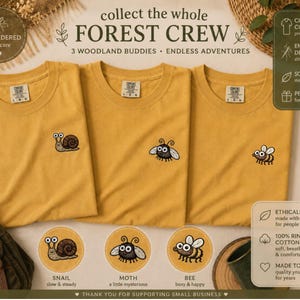 May include: Three mustard-yellow t-shirts with embroidered woodland creature designs: a snail, a moth, and a bee. The text "collect the whole FOREST CREW" is displayed above the shirts. Additional text includes "EMBROIDERED with care" and "3 WOODLAND BUDDIES &bull; ENDLESS ADVENTURES."