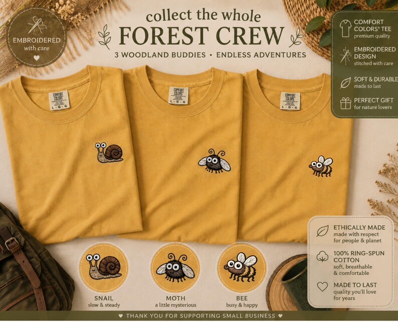 May include: Three mustard-yellow t-shirts with embroidered woodland creature designs: a snail, a moth, and a bee. The text "collect the whole FOREST CREW" is displayed above the shirts. Additional text includes "EMBROIDERED with care" and "3 WOODLAND BUDDIES &bull; ENDLESS ADVENTURES."