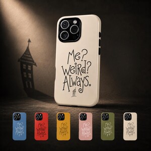 May include: A cream-coloured smartphone case featuring the black text "Me? Weird? Always." and a small house illustration. Below, a row of six identical cases in blue, red, yellow, pink, olive green, and cream are displayed on a dark surface.