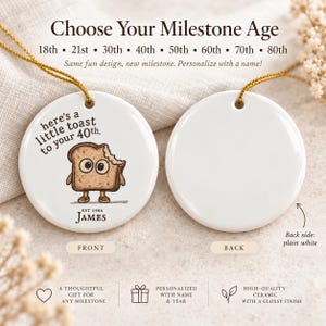 May include: Two round white ceramic ornaments with gold hanging strings. The left ornament features a cartoon toast character with the text 'here's a little toast to your 40th.' and 'EST 1986 JAMES'. The right ornament is plain white on both sides.