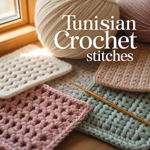 May include: Image showing examples of Tunisian crochet stitches in cream, pink, and green, alongside a golden crochet hook. The text "Tunisian Crochet stitches" is visible. Two balls of yarn in cream and pink are in the background.