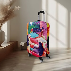 May include: A rolling suitcase covered in a vibrant, abstract art design. The cover features thick brushstrokes of red, pink, blue, green, and purple paint. The suitcase has a black handle and wheels.