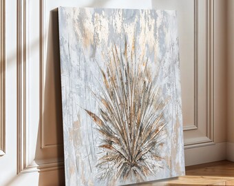May include: A rectangular canvas wall art piece featuring an abstract painting of a large, fan-shaped palm leaf. The artwork uses a palette of metallic gold, soft gray, and white tones with textured, layered brushstrokes creating a dimensional effect.