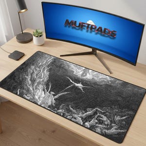 May include: Black and white rectangular desk mat featuring a detailed illustration of a dramatic scene with figures and angels. The mat is placed on a light wood desk, with a curved computer monitor displaying the text "MUFTPADS".