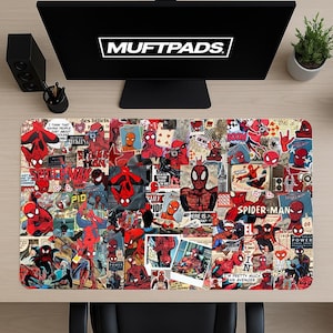 May include: A rectangular desk mat featuring a collage of Spider-Man comic book images in red, black, and blue. The mat has the text "MUFTPADS" at the top. The design includes various Spider-Man poses and comic book panels.