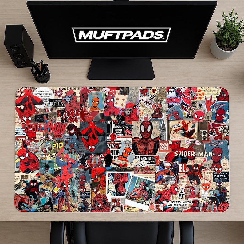 May include: A rectangular desk mat featuring a collage of Spider-Man comic book images in red, black, and blue. The mat has the text "MUFTPADS" at the top. The design includes various Spider-Man poses and comic book panels.