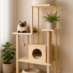 May include: A multi-level wooden cat tree featuring a central cubby house with a circular opening, a sisal-wrapped scratching post, two plush cream-colored circular beds, and a hanging ball toy, with two cats resting on the upper platforms.