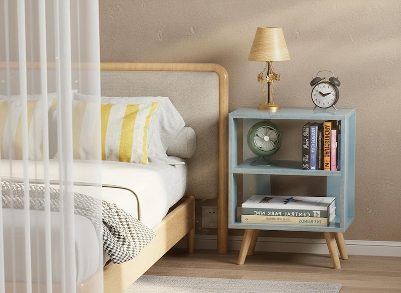 Modern nightstand beside bed with lamp and books, compact bedside table for small bedroom