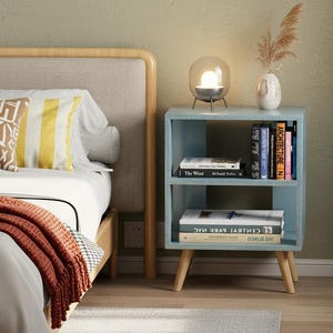Compact side table used as bedside nightstand with décor and books