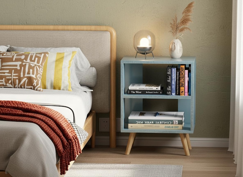 Compact side table used as bedside nightstand with décor and books