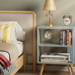 Small nightstand with storage shelf next to bed in modern interior