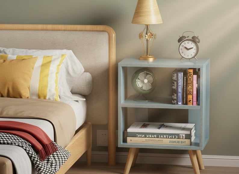 Small nightstand with storage shelf next to bed in modern interior