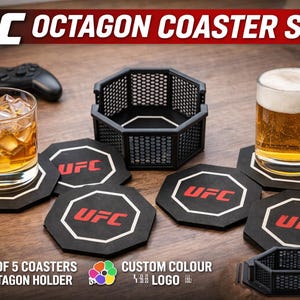 May include: UFC Octagon Coaster Set featuring black coasters with the UFC logo in red and white, and an octagon-shaped holder. A glass of whiskey and a beer mug sit on the coasters. The set includes 5 coasters and an octagon holder.