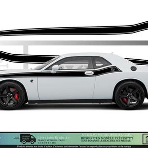 May include: White coupe with black racing stripes and a logo. The stripes are designed to fit the car's body, with a curved design and a logo near the rear. The car has black wheels and red brake calipers.