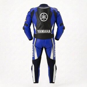 May include: A blue, black, and white leather motorcycle racing suit featuring the Yamaha logo and text on the back. The suit includes a protective back hump, articulated joints at the elbows and knees, and white accents along the legs and torso.