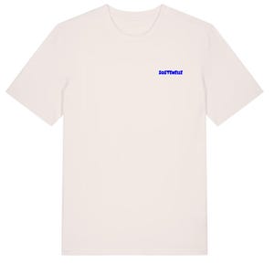 May include: Off-white t-shirt with short sleeves. The word "SOSTENELLE" is printed in blue on the upper chest area. The shirt has a crew neck and a simple, minimalist design, suitable for casual wear.