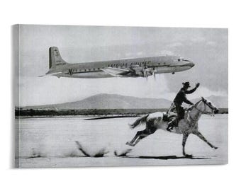 May include: Black and white canvas print featuring a vintage image of a cowboy on horseback, with an American Airlines plane flying overhead. The cowboy is waving, and the horse is running across a desert landscape.