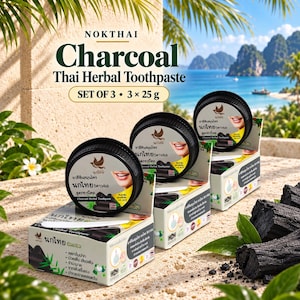 May include: A set of three Nokthai Charcoal Thai Herbal Toothpaste containers, each 25g, featuring black circular lids with a bird logo and a smiling mouth graphic. The packaging includes white boxes with Thai text, green bamboo illustrations, and a small white spatula.